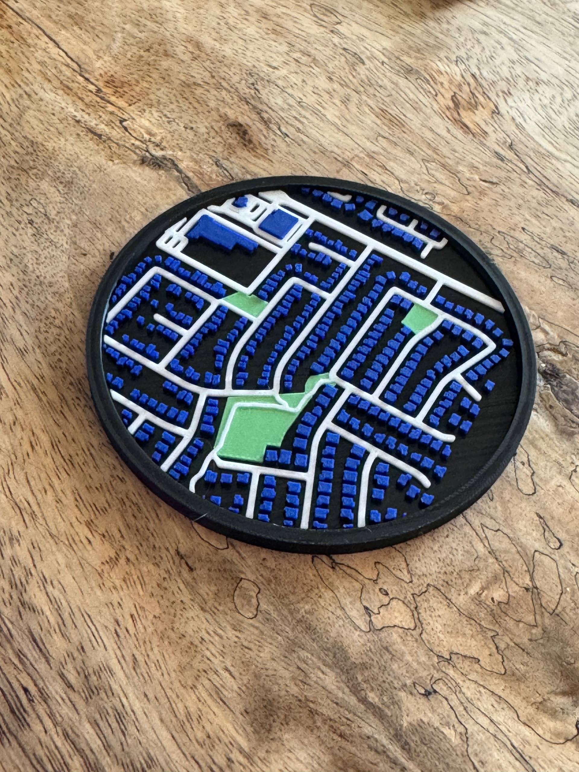 The first physical prototype of the custom map coaster, fresh off the Bambu Lab X1C printer